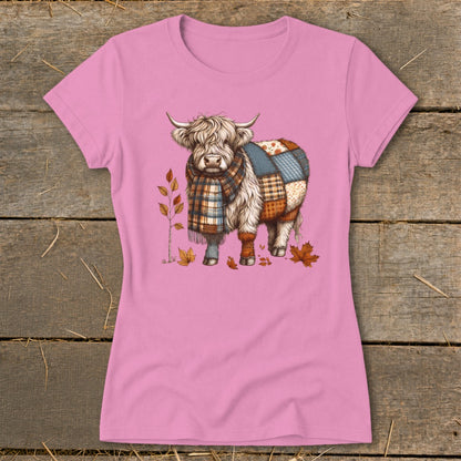 Highland cow with plaid scarf and patchwork body on pink t-shirt.