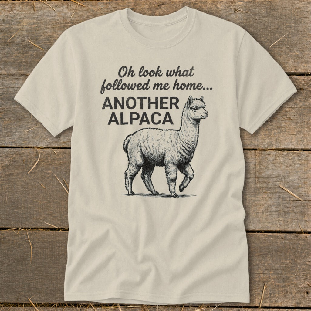 Cream t-shirt with text "Oh look what followed me home... ANOTHER ALPACA" and an alpaca graphic.