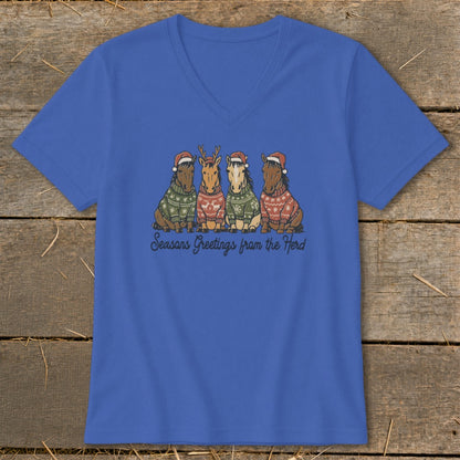 Four horses wearing Santa hats and Christmas sweaters with the text "Seasons Greetings from the Herd".