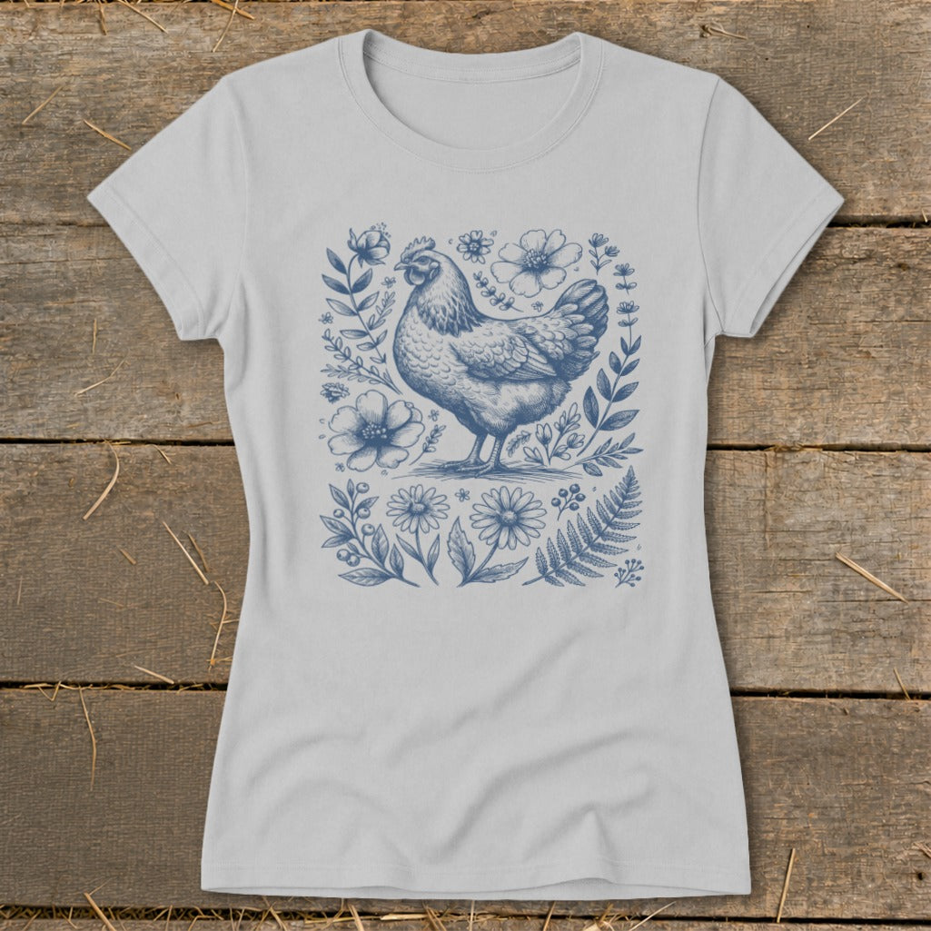 Light grey t-shirt with a blue line art illustration of a chicken surrounded by flowers.