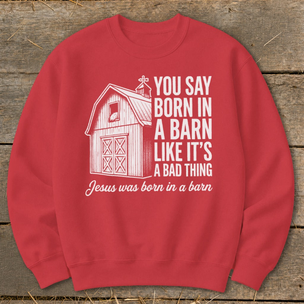 Red sweatshirt with barn graphic and text "You say born in a barn like it's a bad thing Jesus was born in a barn".