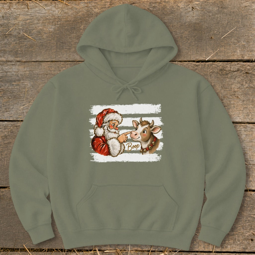 Santa booping a cow's nose with the word "Boop" on a hoodie.