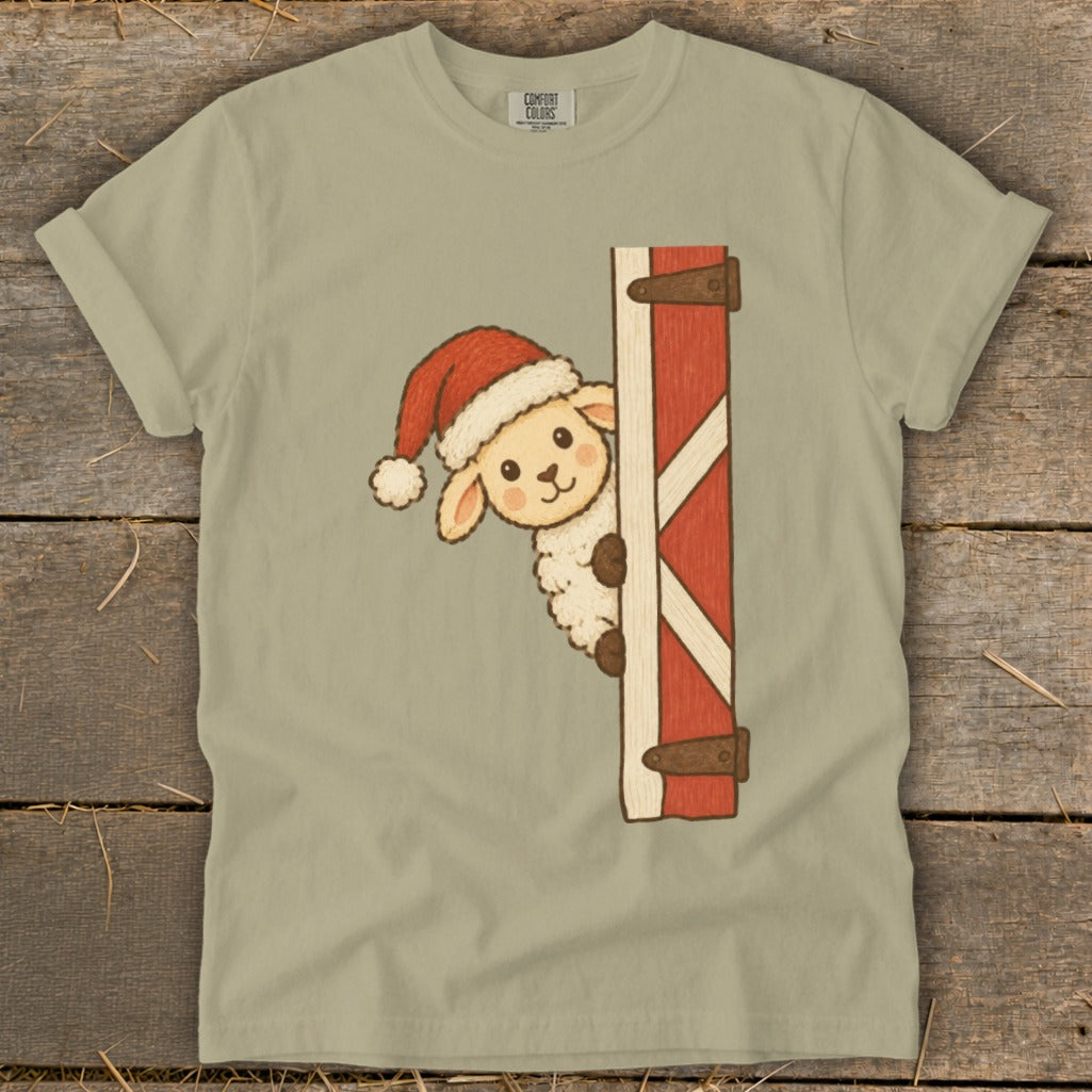 Fluffy sheep wearing Santa hat peeking from behind barn door.