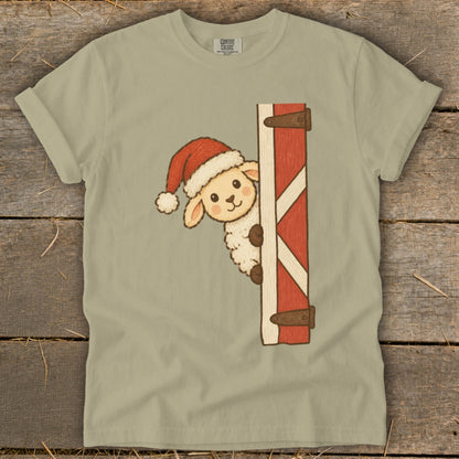 Fluffy sheep wearing Santa hat peeking from behind barn door.