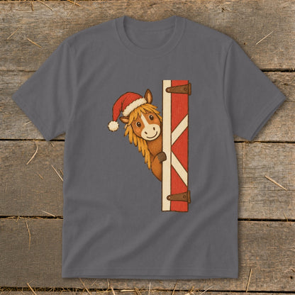 Horse wearing Santa hat peeking around a barn door graphic on a t-shirt.