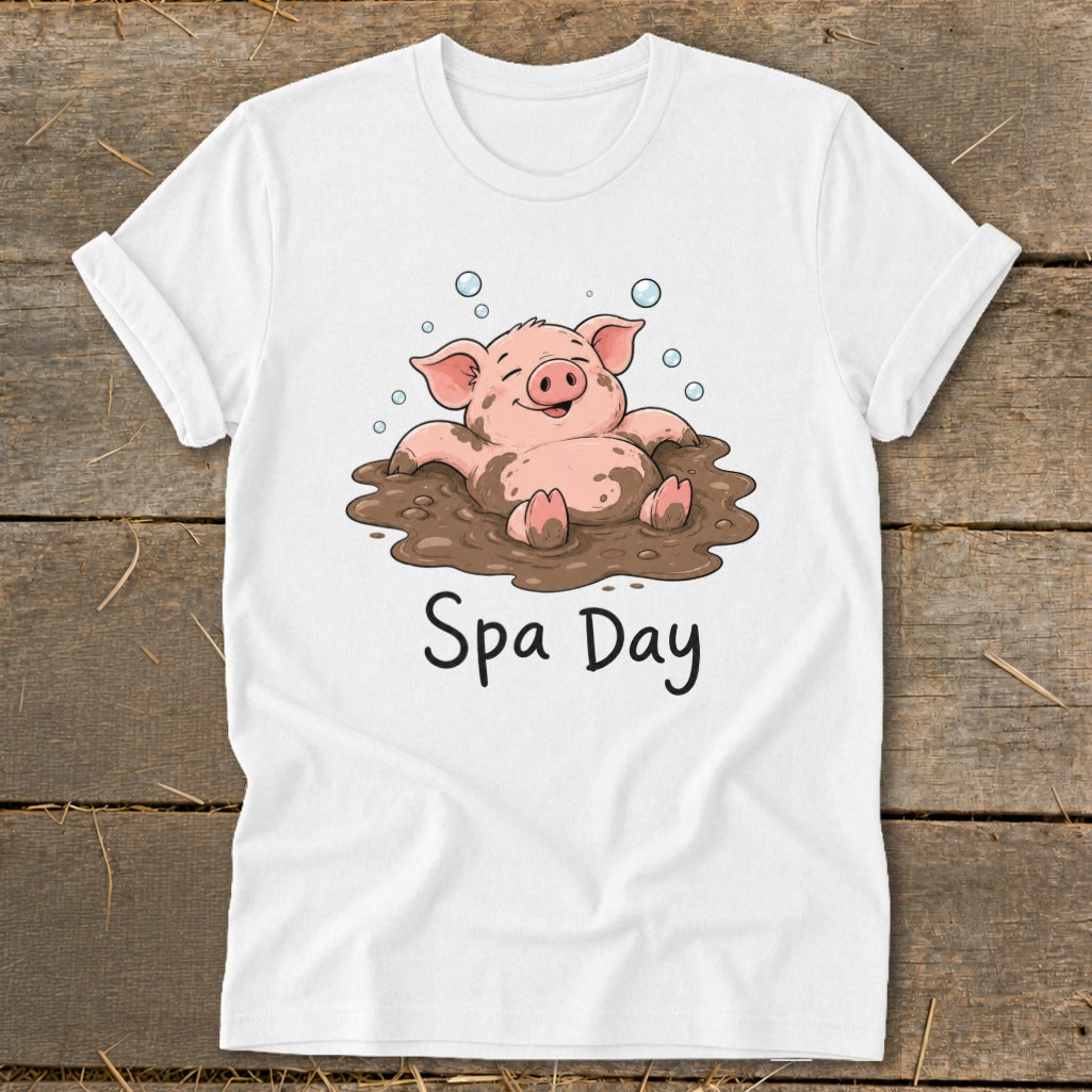 White t-shirt with a cartoon pig relaxing in mud with "Spa Day" text.