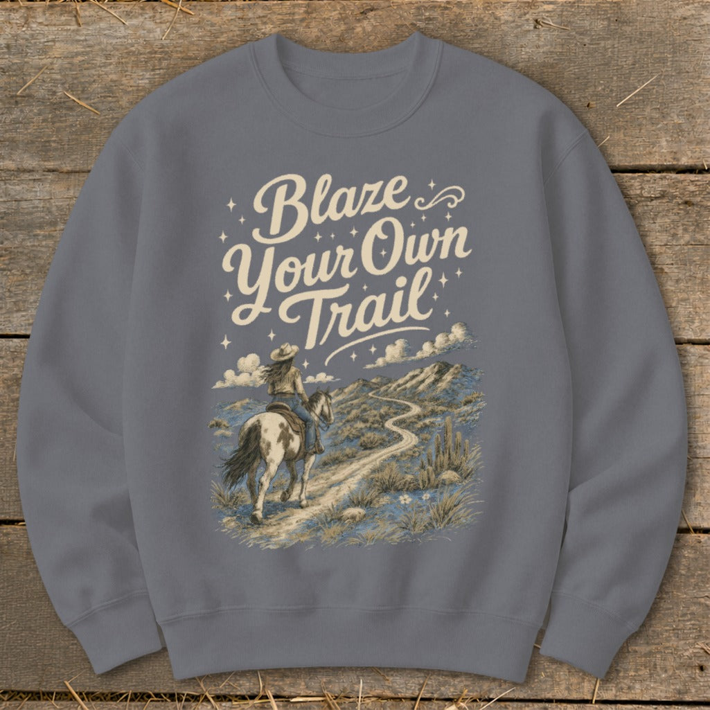Crewneck sweatshirt with "Blaze Your Own Trail" text and desert landscape featuring a person riding a horse.