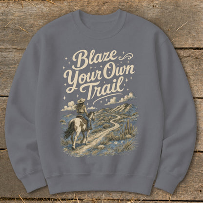 Crewneck sweatshirt with "Blaze Your Own Trail" text and desert landscape featuring a person riding a horse.