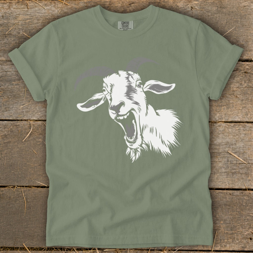 Sage green t-shirt with a white cartoon goat head screaming design.
