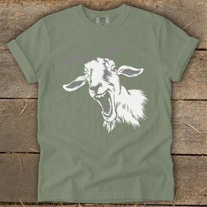 Sage green t-shirt with a white cartoon goat head screaming design.
