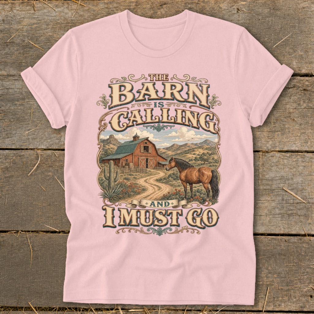 Pink T-shirt with text "The Barn is Calling and I Must Go" and countryside scene.