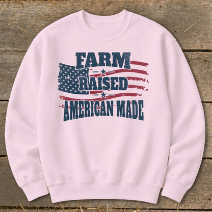 Pink sweatshirt with distressed American flag and text "FARM RAISED AMERICAN MADE".
