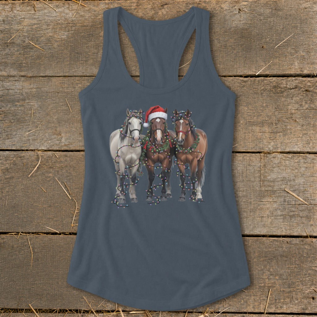 Three horses in Christmas lights, one wearing a Santa hat.