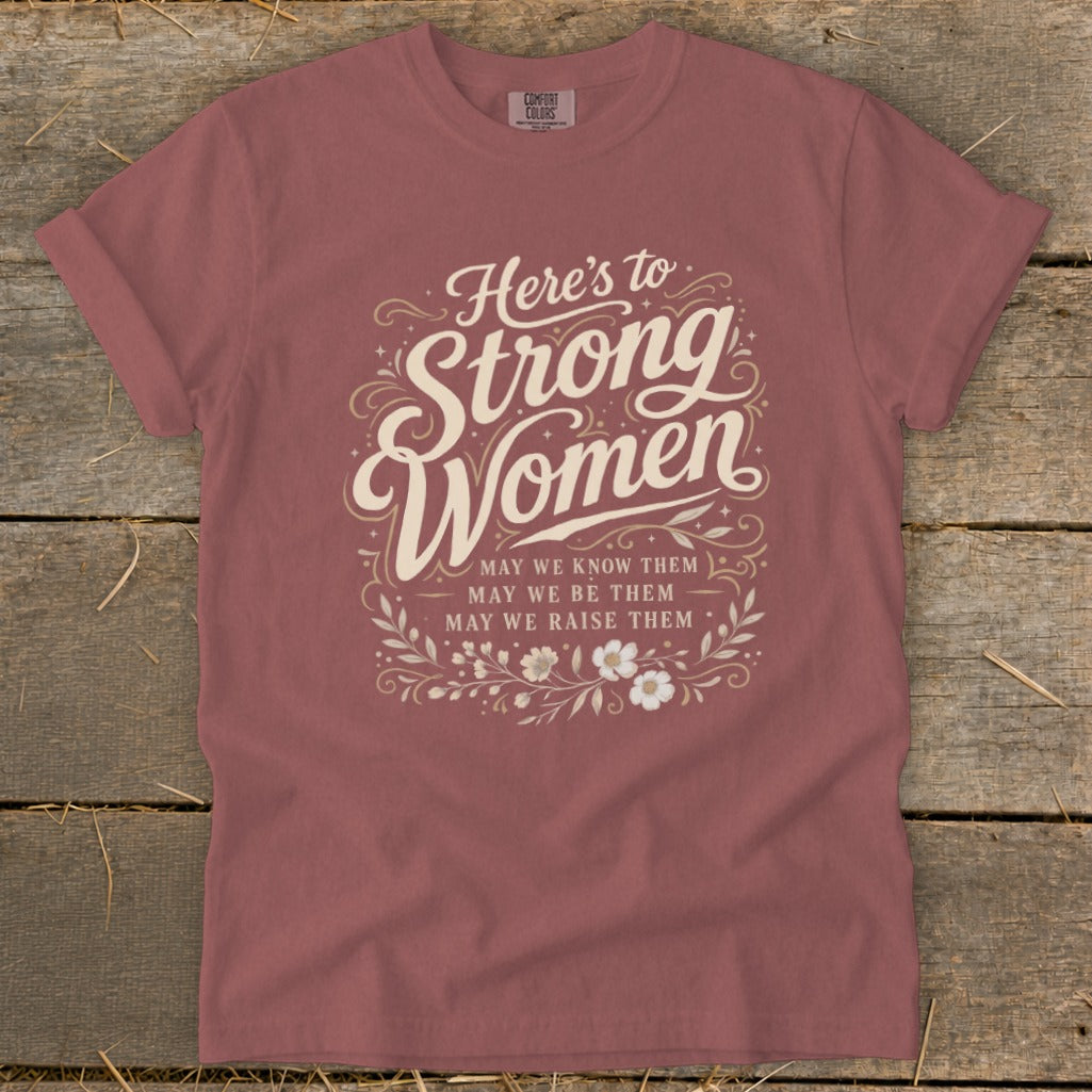 T-shirt with "Here's to Strong Women" graphic and floral accents.