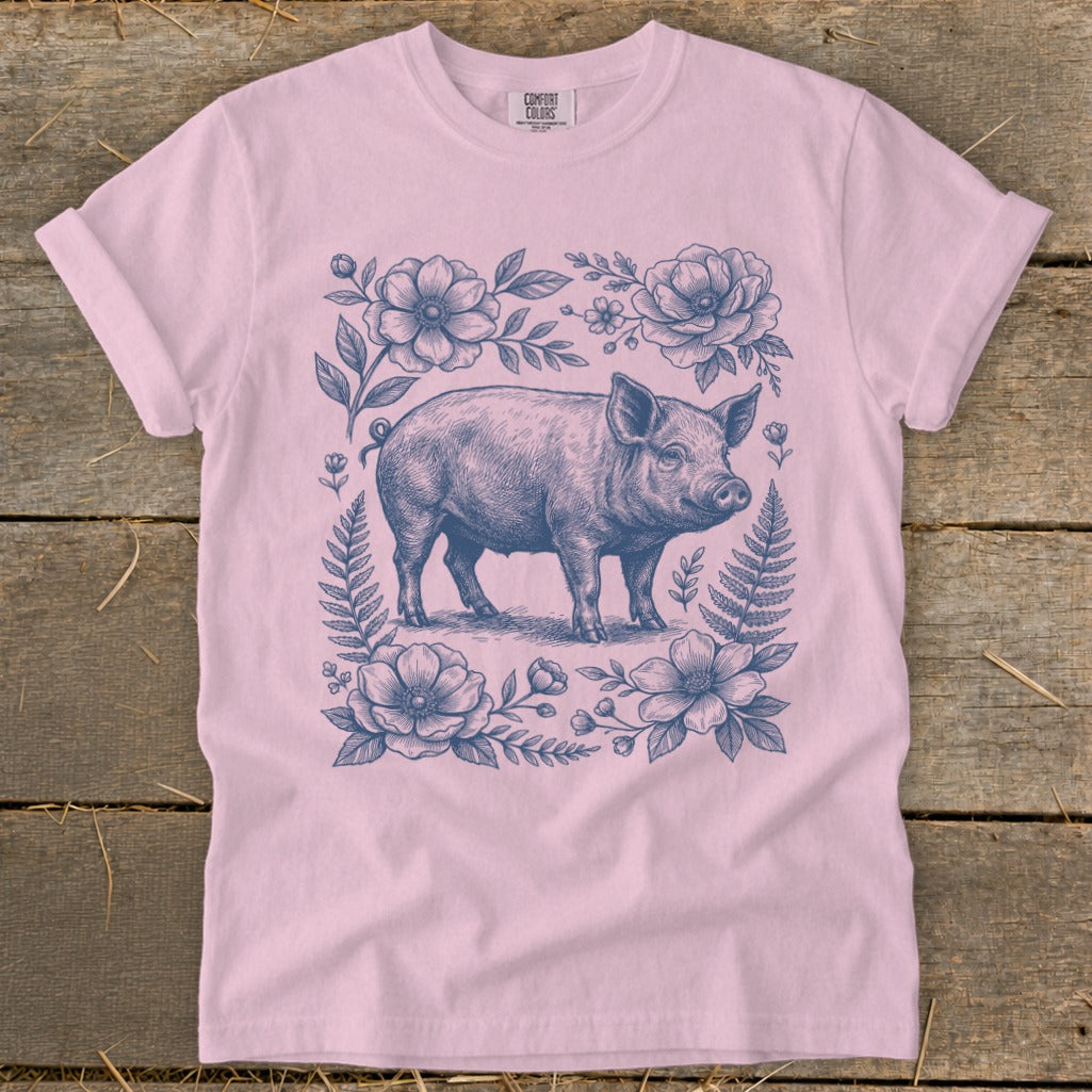 Pink t-shirt with a vintage-style pig and floral illustration.