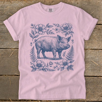 Pink t-shirt with a vintage-style pig and floral illustration.