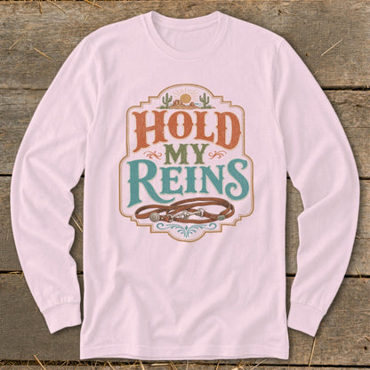 Pink long-sleeve shirt with "Hold My Reins" text and horse reins graphic.