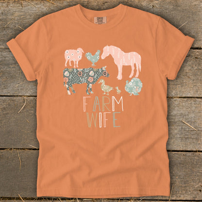 Orange t-shirt with "FARM WIFE" text and assorted farm animals in floral patterns.