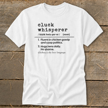 White t-shirt with "cluck whisperer" definition: fluent in chicken gossip, hugs hens daily.