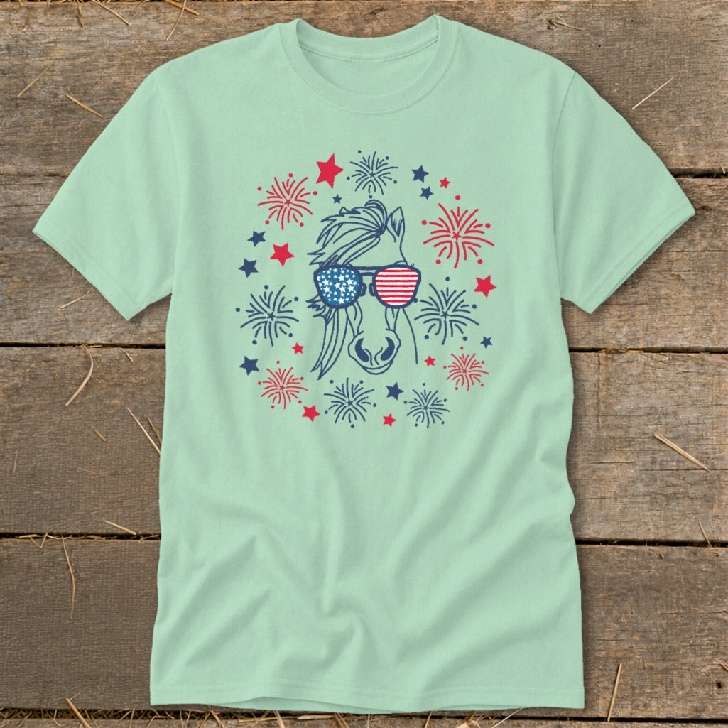 Light mint t-shirt with a horse wearing American flag sunglasses and surrounded by fireworks.