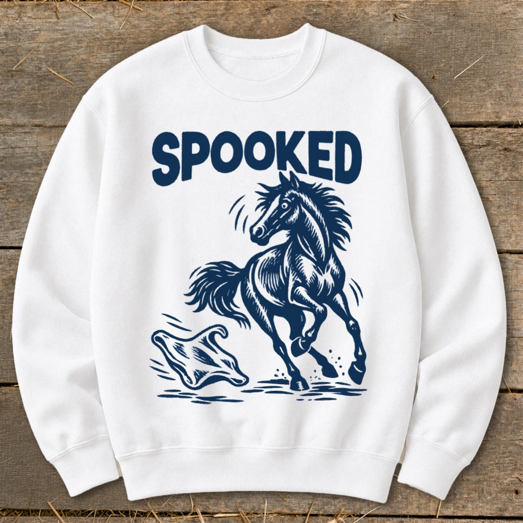 White sweatshirt with "SPOOKED" text and a startled horse facing a ghost.