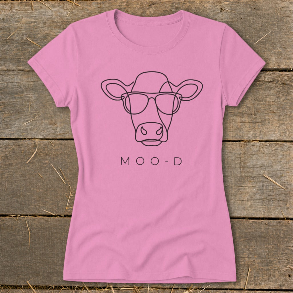 Pink t-shirt with a minimalist line drawing of a cow wearing sunglasses and the text MOO-D.