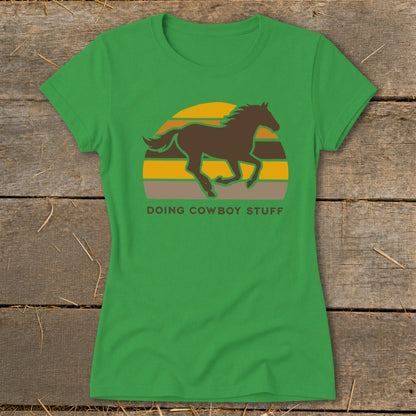 Green t-shirt with a brown horse silhouette and "DOING COWBOY STUFF" text.
