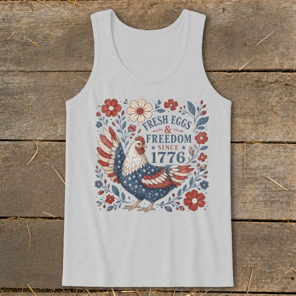 White tank top with patriotic chicken design and "Fresh Eggs & Freedom Since 1776" text.