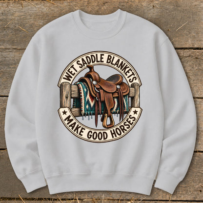 Light grey sweatshirt with a circular graphic of a western saddle on a fence with a patterned blanket.
