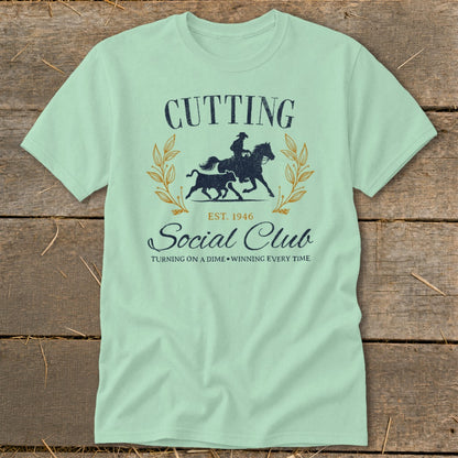 Light green t-shirt with "Cutting Social Club" text and a horse and calf graphic.
