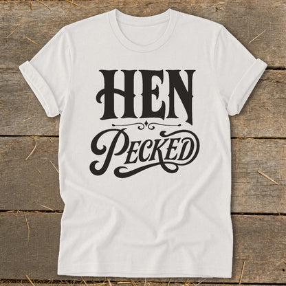 White t-shirt with black text reading "HEN PECKED" in decorative fonts.