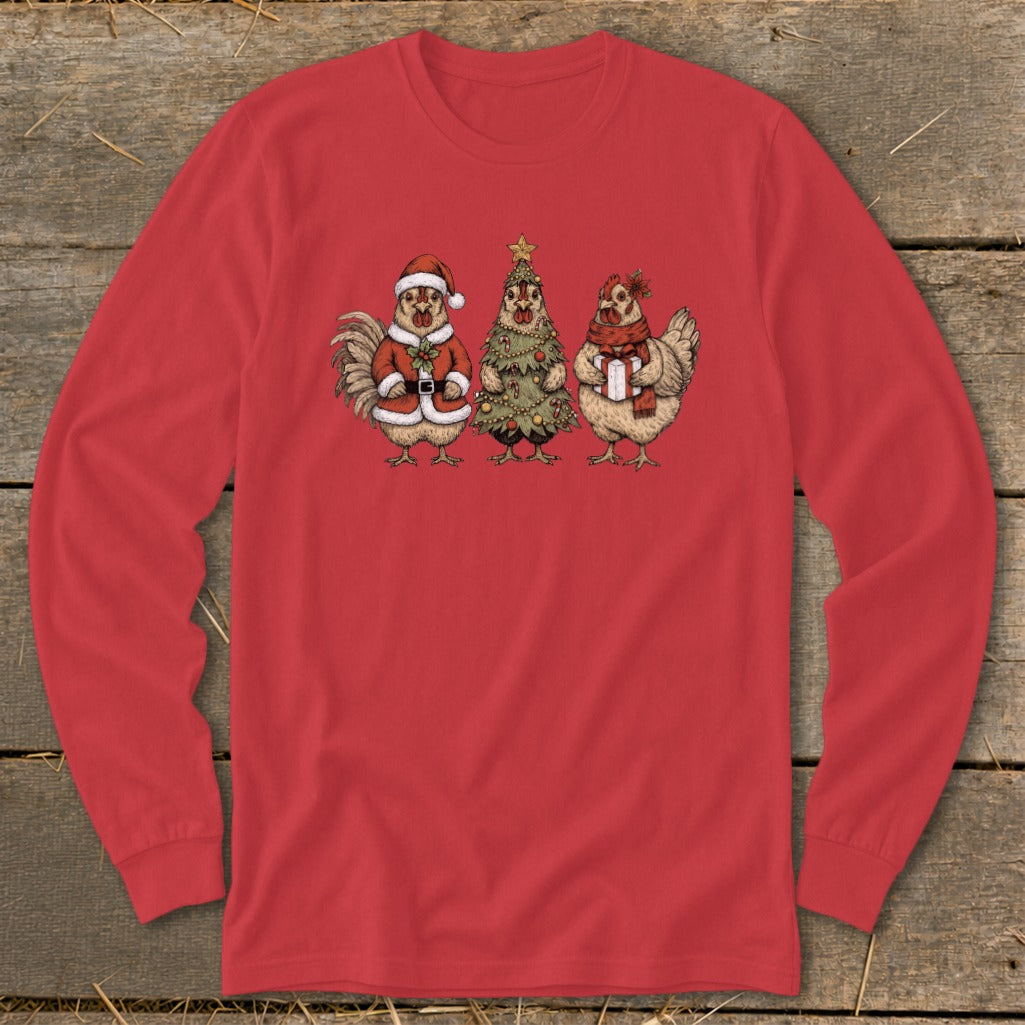 Three chickens dressed for Christmas, one as Santa, one as a tree, and one holding a gift.