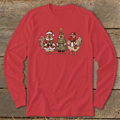 Three chickens dressed for Christmas, one as Santa, one as a tree, and one holding a gift.