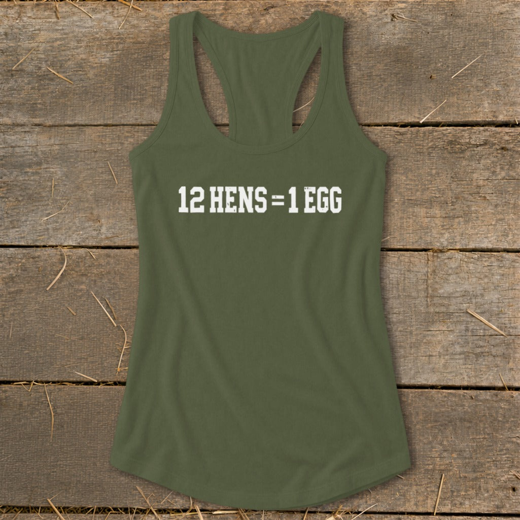 Olive green racerback tank top featuring the white text 12 HENS = 1 EGG laid flat on a wooden surface.