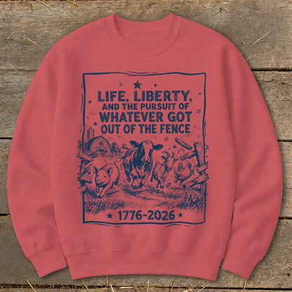 Red sweatshirt with a blue farm animal graphic and text: "Life, Liberty, and the Pursuit of Whatever Got Out of the Fence 1776-2026".