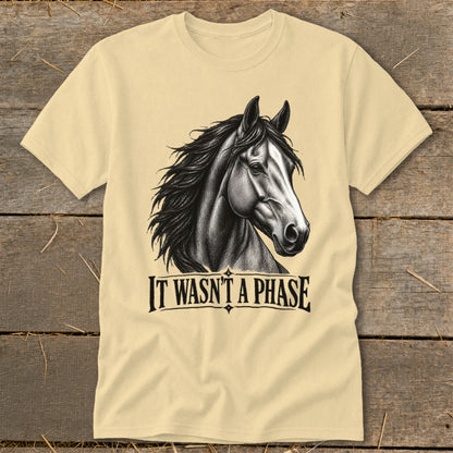Cream t-shirt with a black and white drawing of a horse and text "IT WASN'T A PHASE".