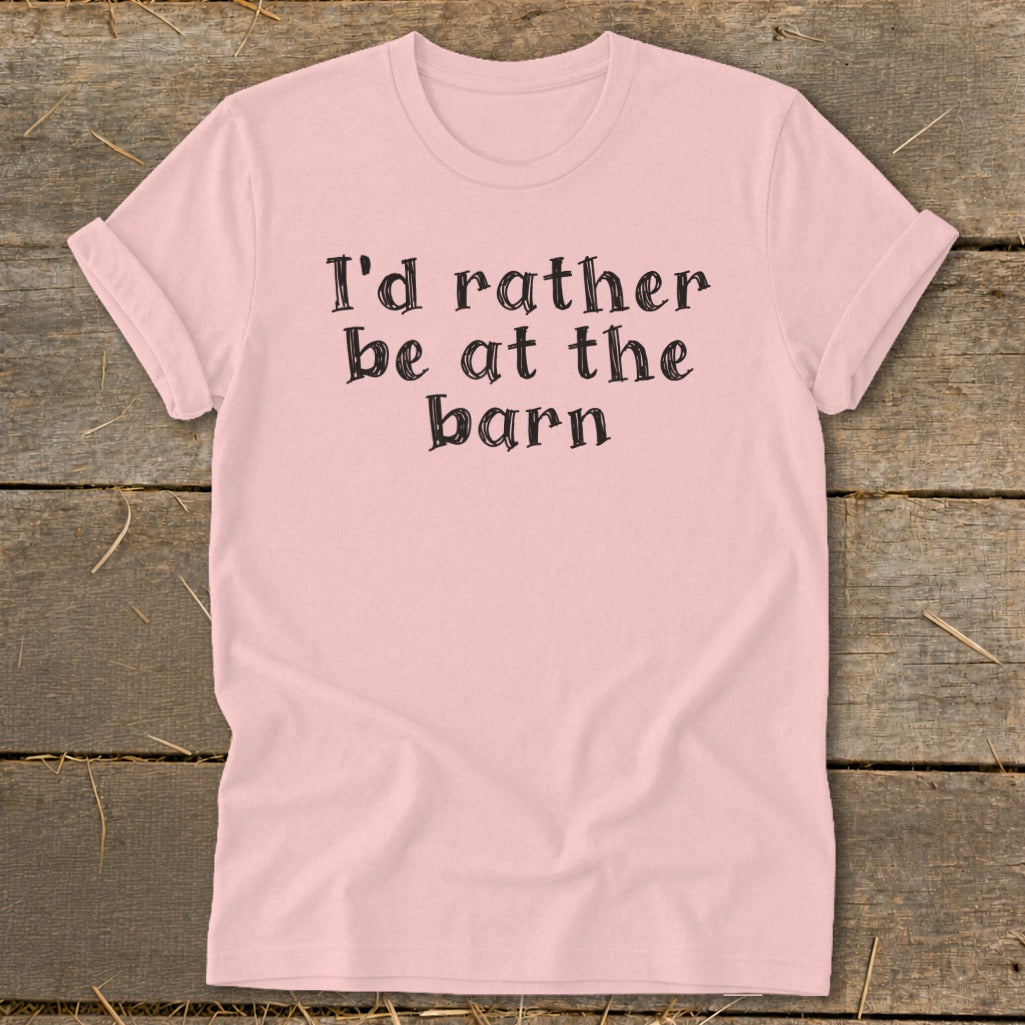 Pink t-shirt with black text that reads "I'd rather be at the barn."