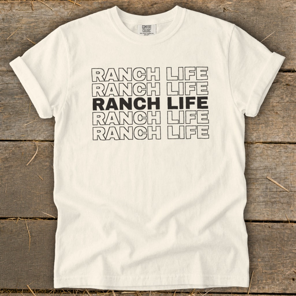 A cream-colored t-shirt with the words "RANCH LIFE" repeated five times on the chest.