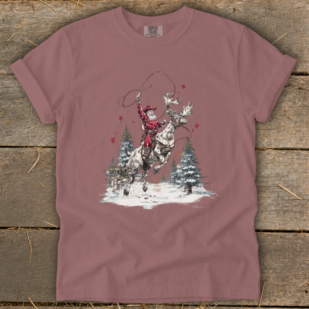 Santa Claus rides a reindeer, lassoing in a snowy forest scene.