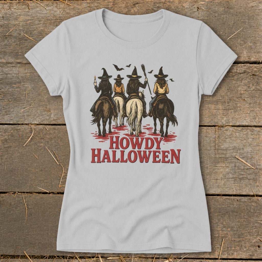 Four witches on horseback ride forward with brooms and bats, text reads "HOWDY HALLOWEEN".