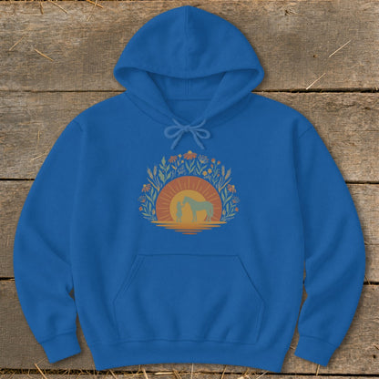 Blue hoodie with a graphic of a person and horse at sunset surrounded by flowers.