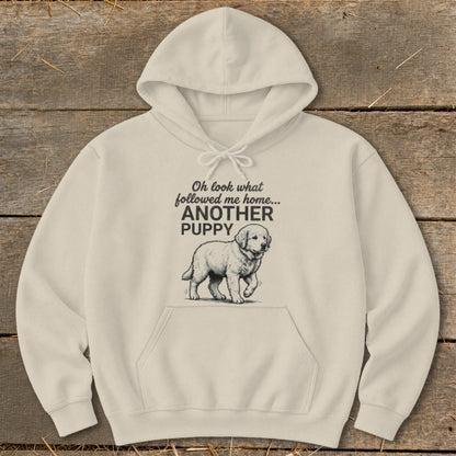 Cream hoodie with text "Oh look what followed me home... ANOTHER PUPPY" and puppy illustration.