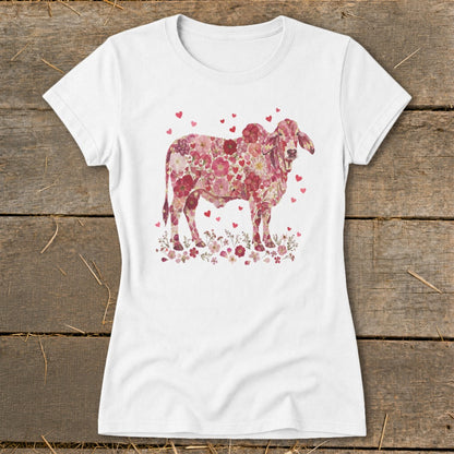 White t-shirt with a pink floral cow graphic and small hearts.