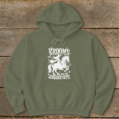 Green hoodie with white graphic of witch on horseback and text "BROOMS ARE FOR amateurs".