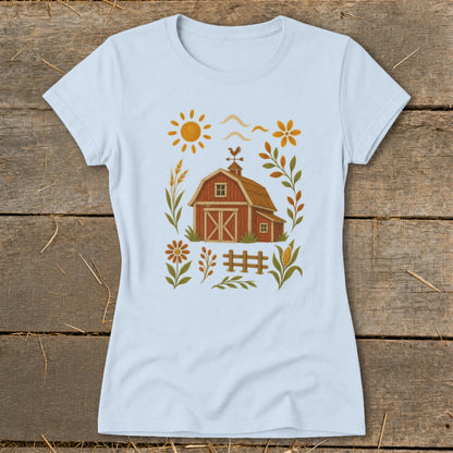 Light blue t-shirt with a barn, sun, fence, and autumn foliage graphic.