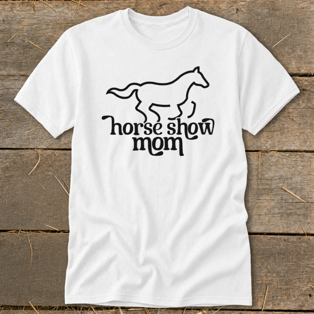 White t-shirt with a black outline of a galloping horse and text "horse show mom".
