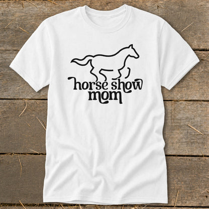 White t-shirt with a black outline of a galloping horse and text "horse show mom".