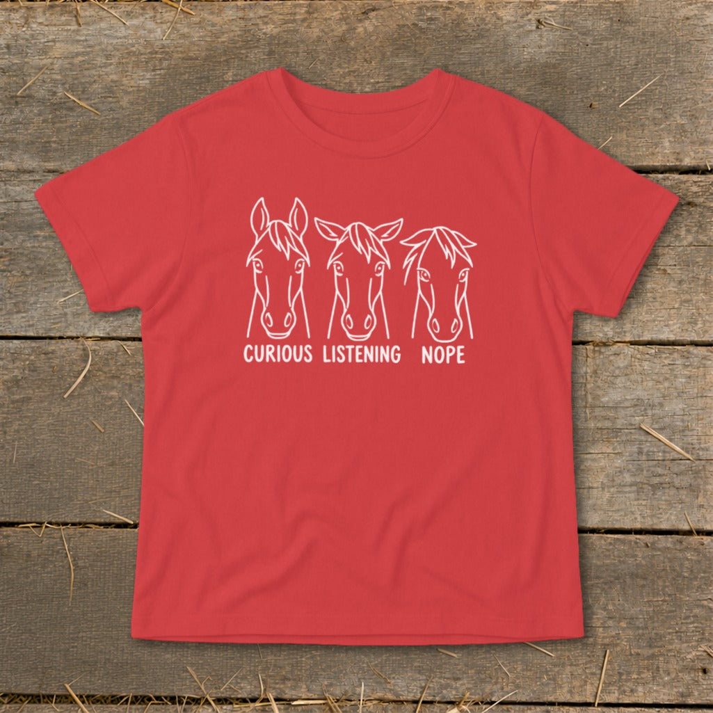 Red short-sleeve t-shirt featuring three horse line drawings labeled Curious, Listening, and Nope.