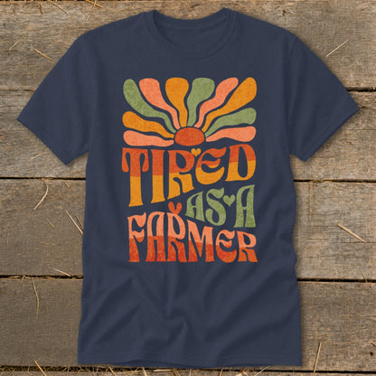 Navy t-shirt with "TIRED AS A FARMER" text and retro sun design.
