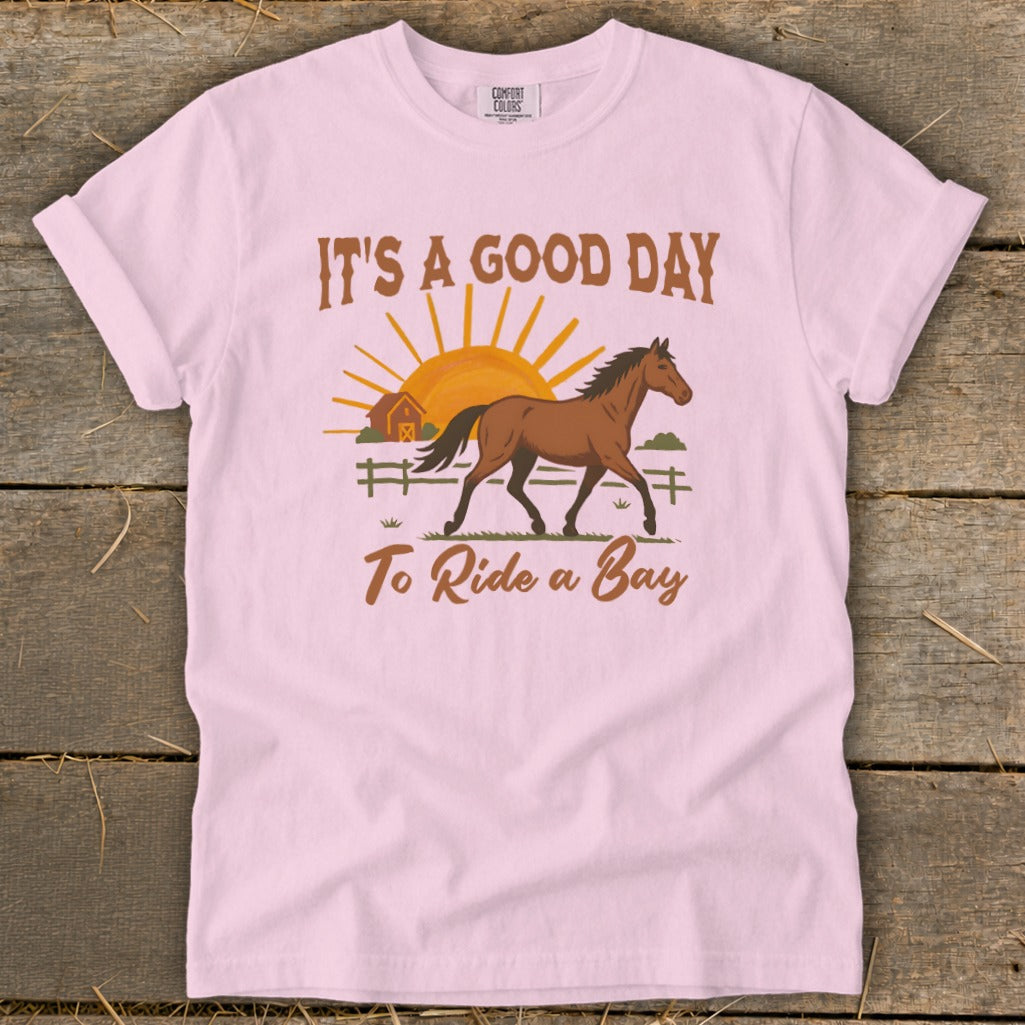 Pink t-shirt with "It's a good day to ride a bay" and horse graphic.
